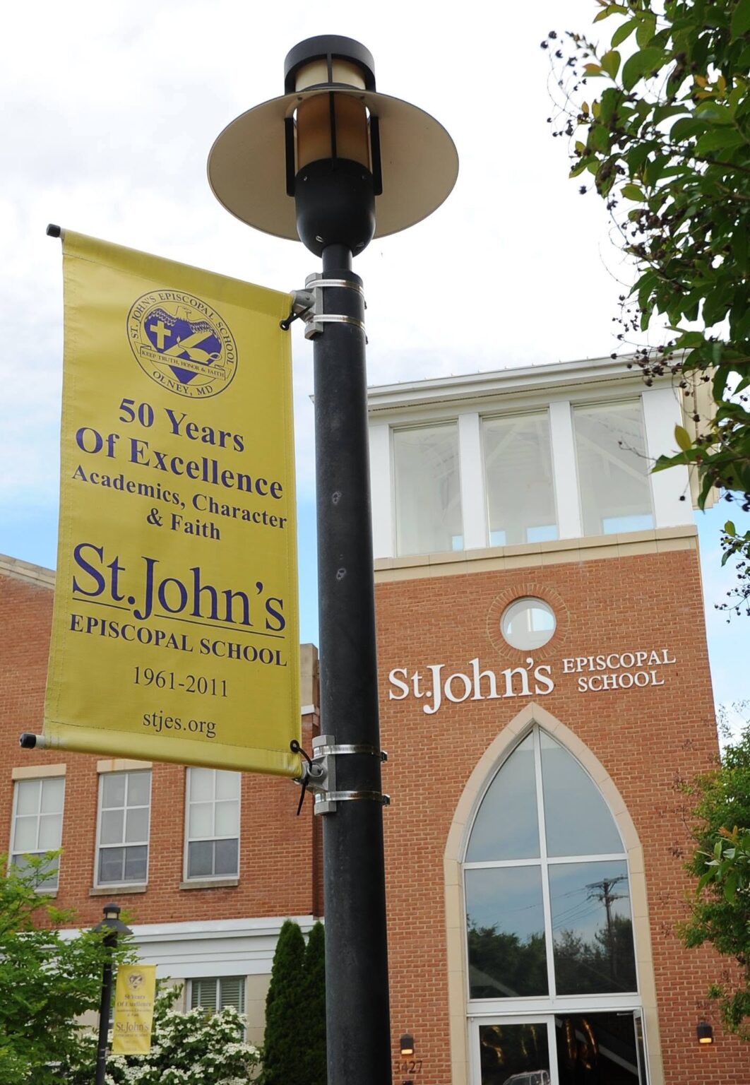 St. John's Episcopal School building with a banner and signage in the foreground